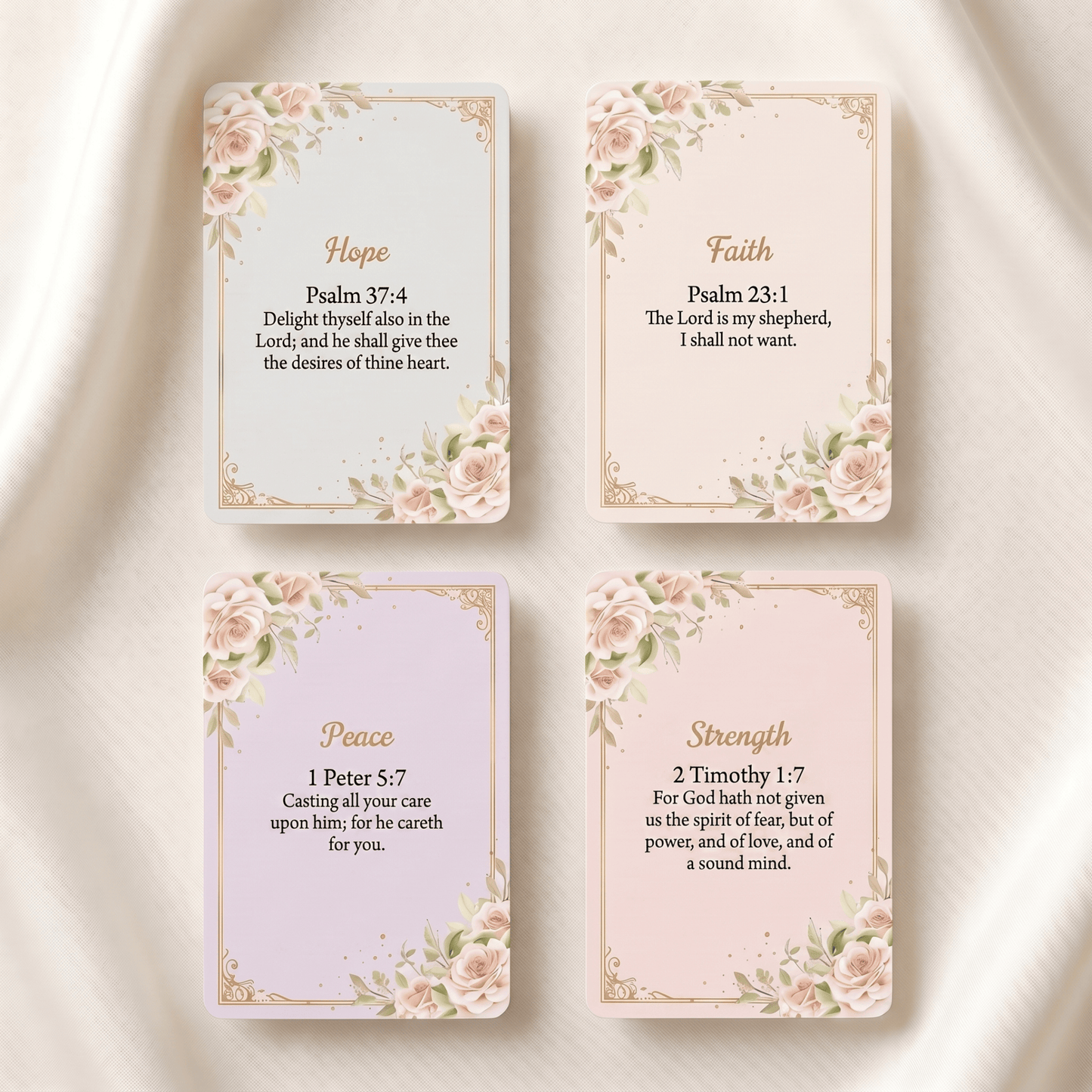 Four decorative cards arranged in a 2x2 grid on a soft white fabric background. The cards feature floral corner designs and gold borders, with the words Hope, Faith, Peace, and Strength at the top, and Bible verse text below.
